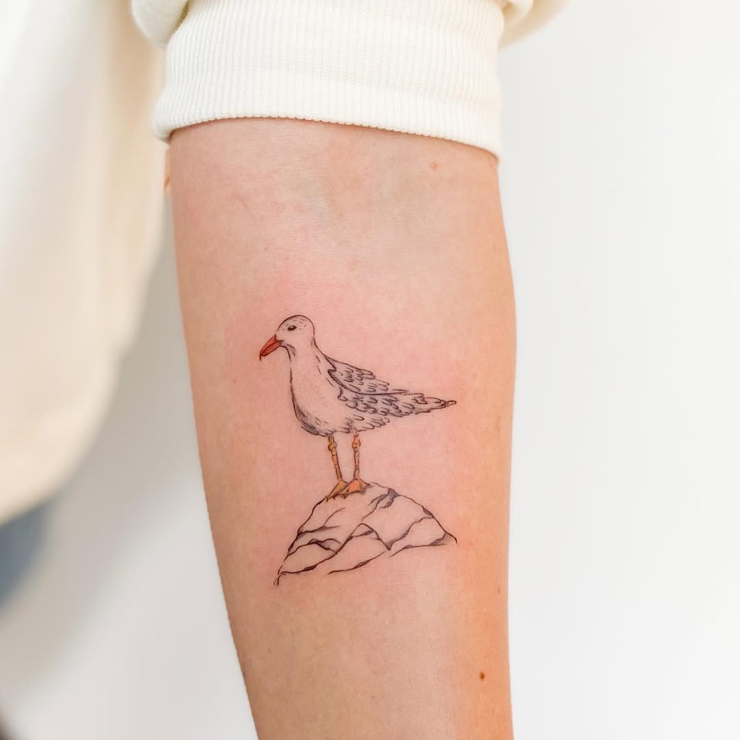 Minimalist seagull tattoo perched on a rock Tattoo Design