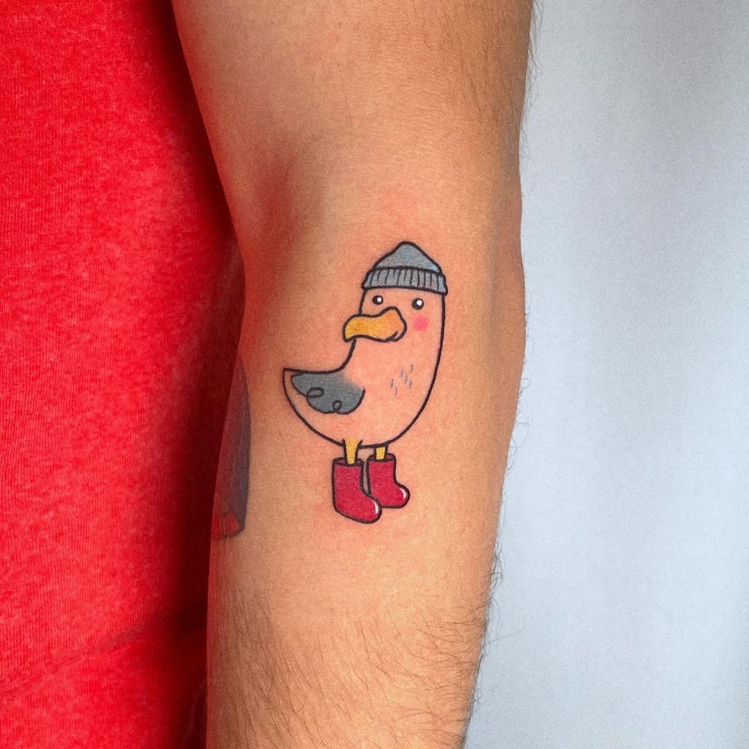 Playful seagull tattoo in vibrant colors Tattoo Design