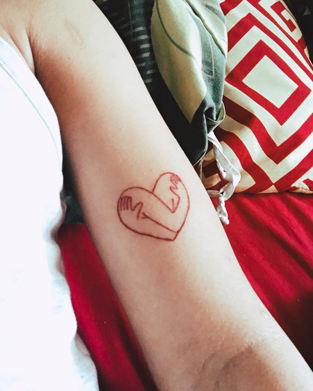 A heart embraced by hands tattoo design Tattoo Design
