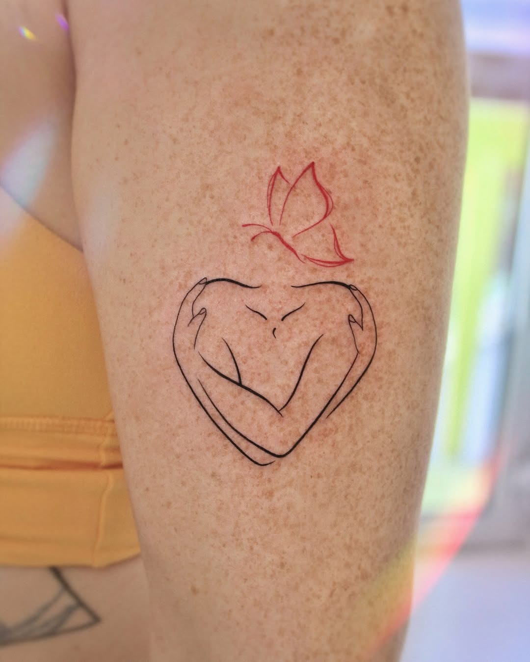 Artistic Heart Embrace with Floral Accent Tattoo Design