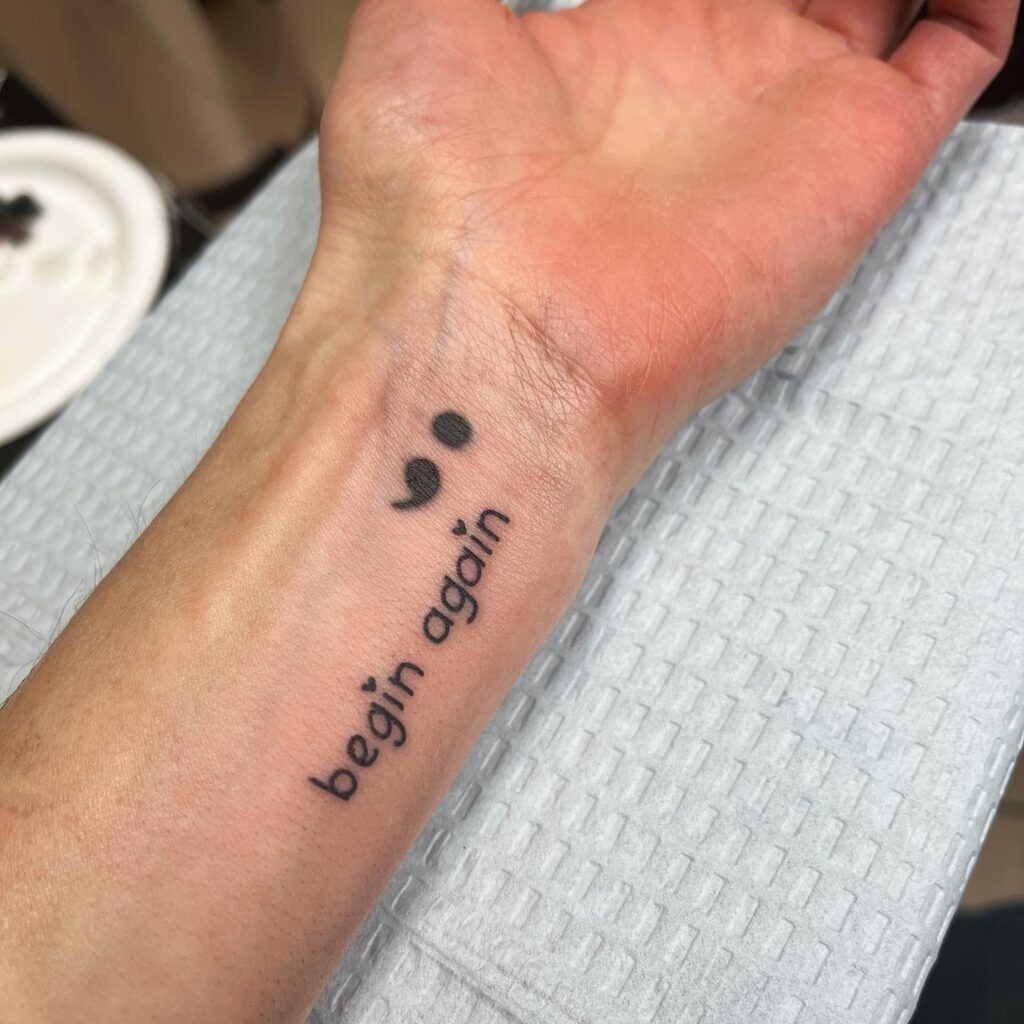 Wave-Inspired Semi-Colon Tattoo with “Of the Sea” Script Tattoo Design
