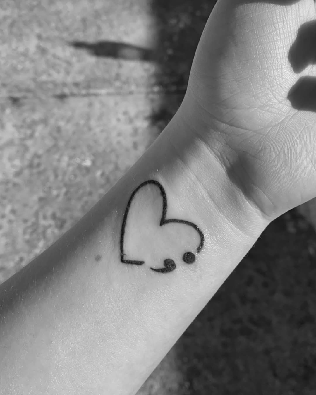 Heart-shaped semicolon tattoo on wrist Tattoo Design