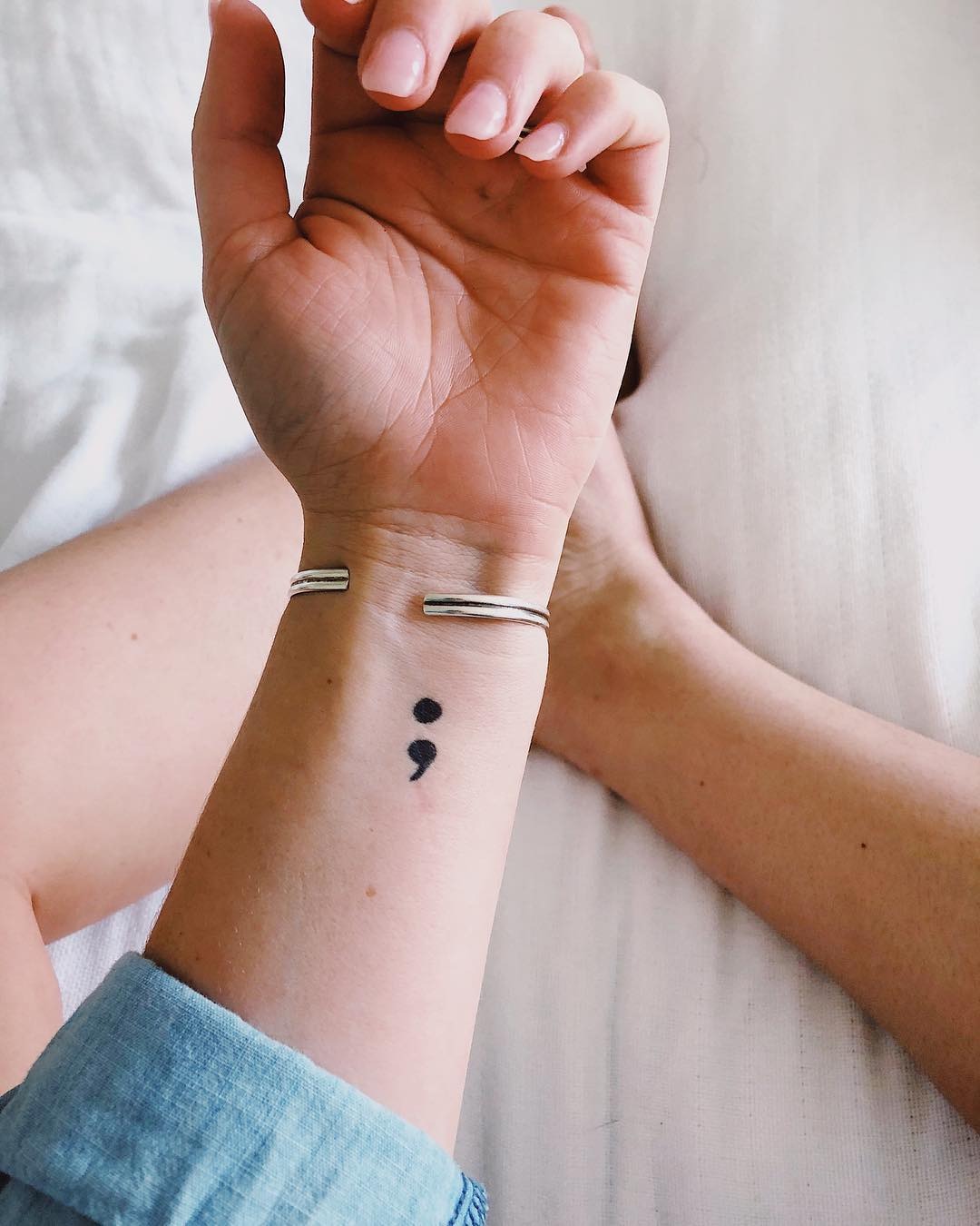Minimalist semicolon tattoo on a wrist. Tattoo Design