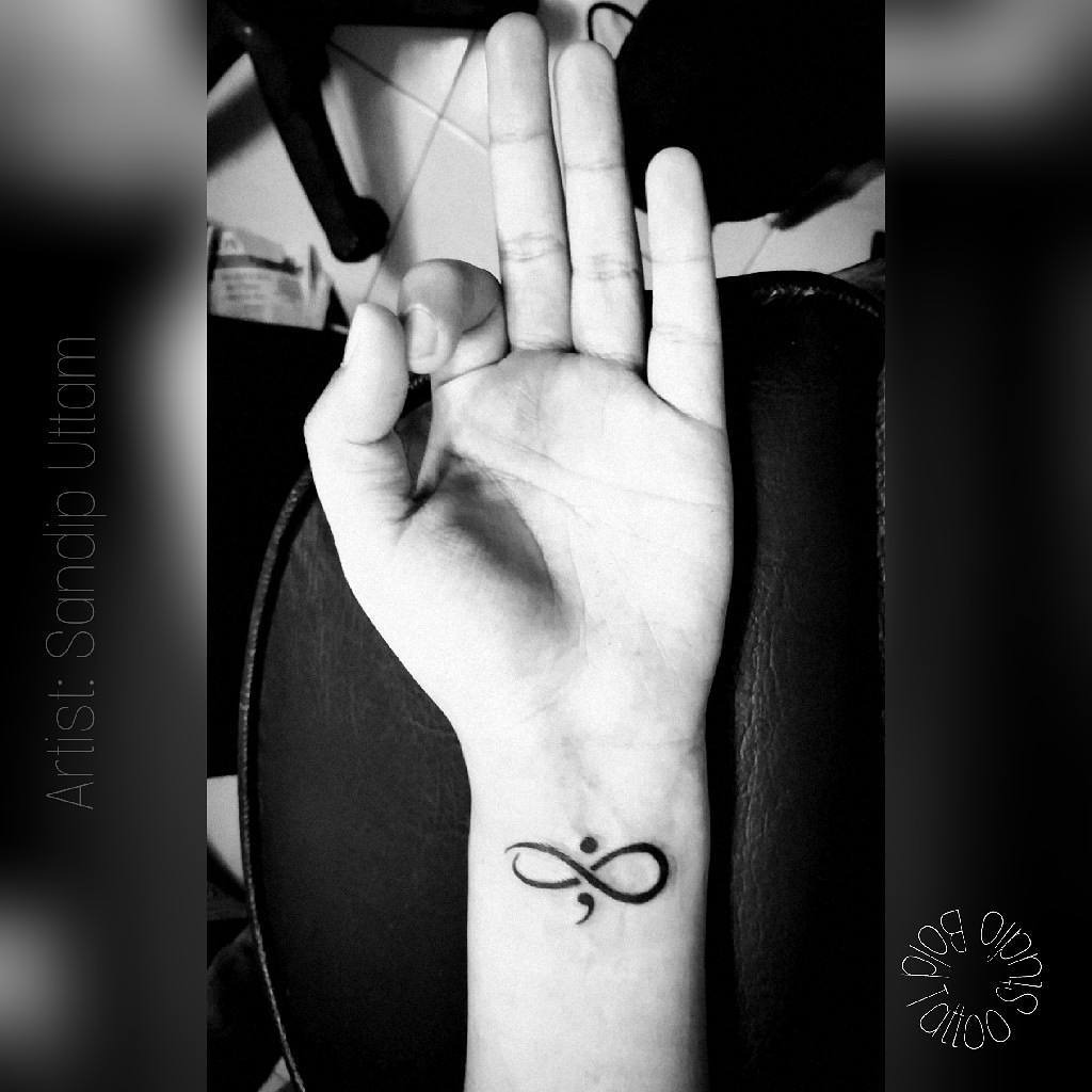 Minimalistic semicolon tattoo with artistic flair Tattoo Design