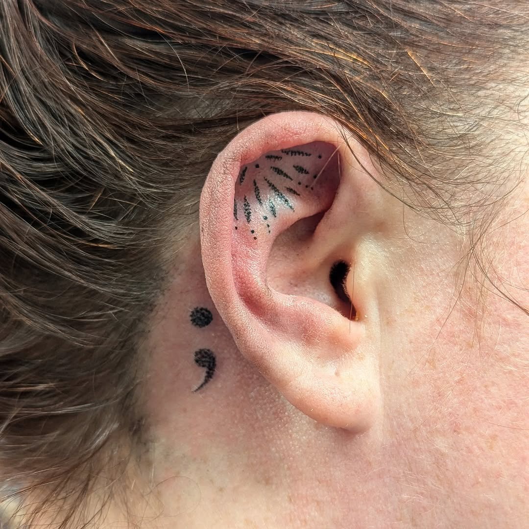 Unique semicolon tattoo behind the ear Tattoo Design