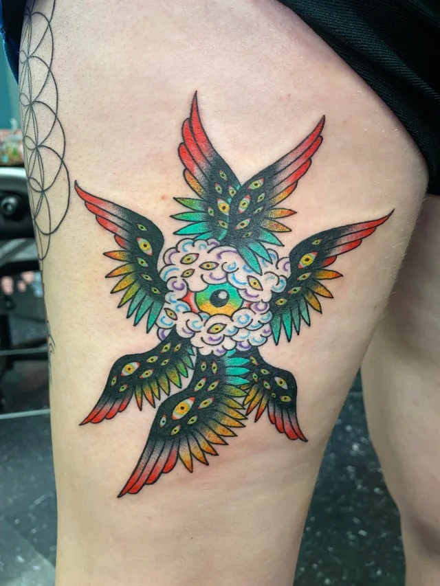 Layered Eyes and Wings Tattoo Design