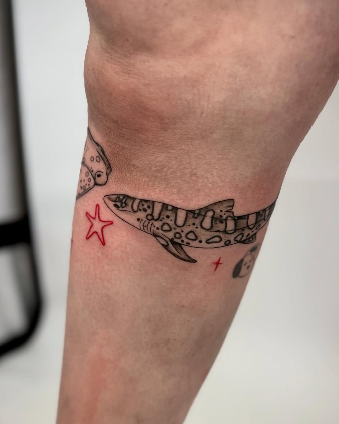 Bold shark design with playful star details Tattoo Design