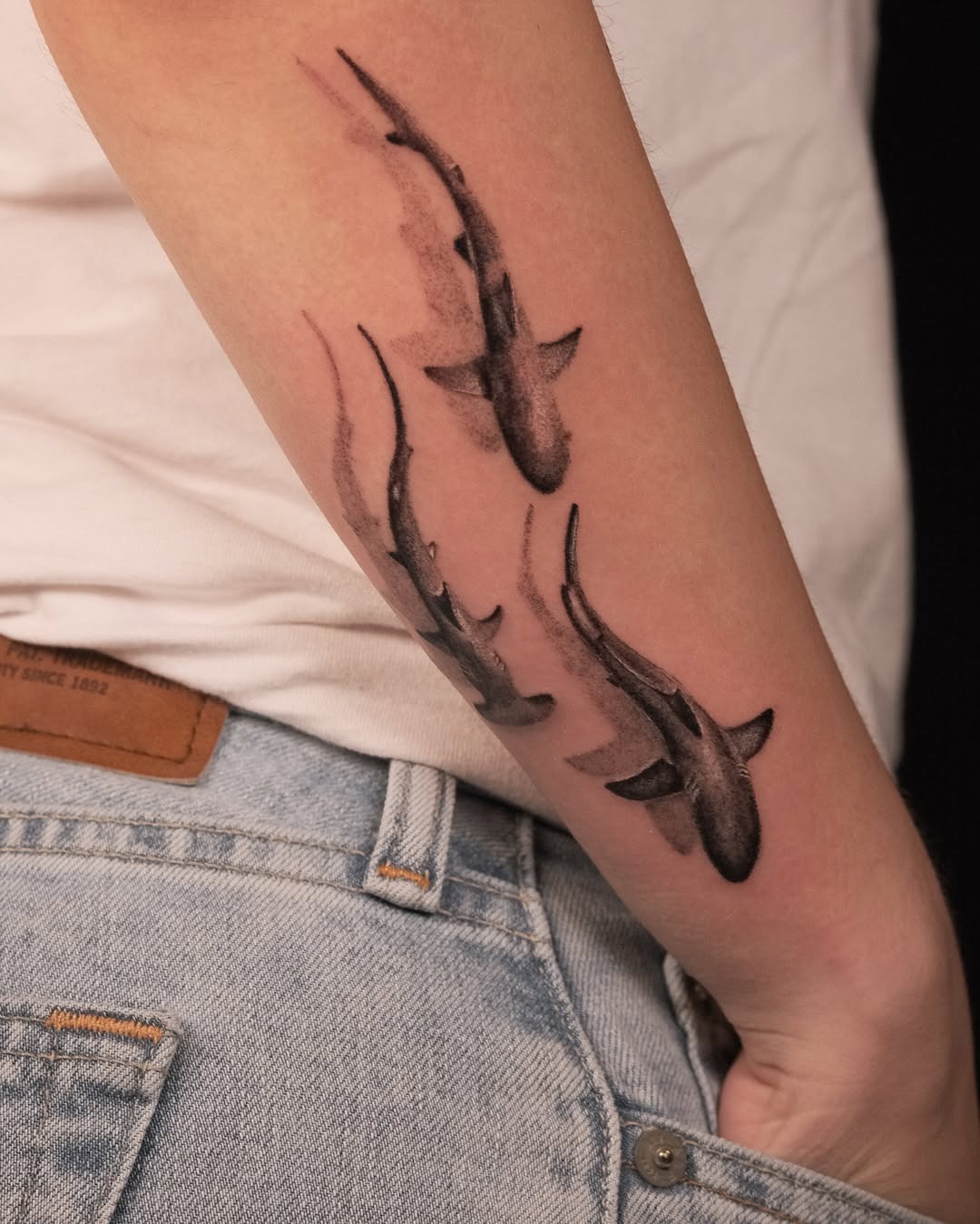 Dynamic shark tattoos creating a flowing effect Tattoo Design