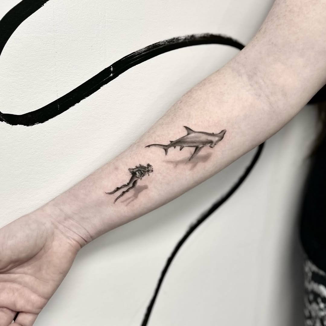 Intricate shark tattoo paired with diver silhouette Tattoo Design