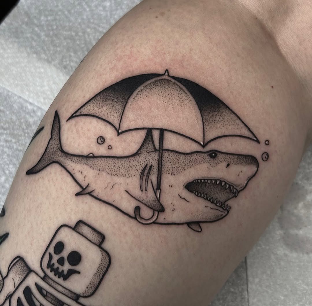 Playful shark tattoo with an umbrella twist Tattoo Design