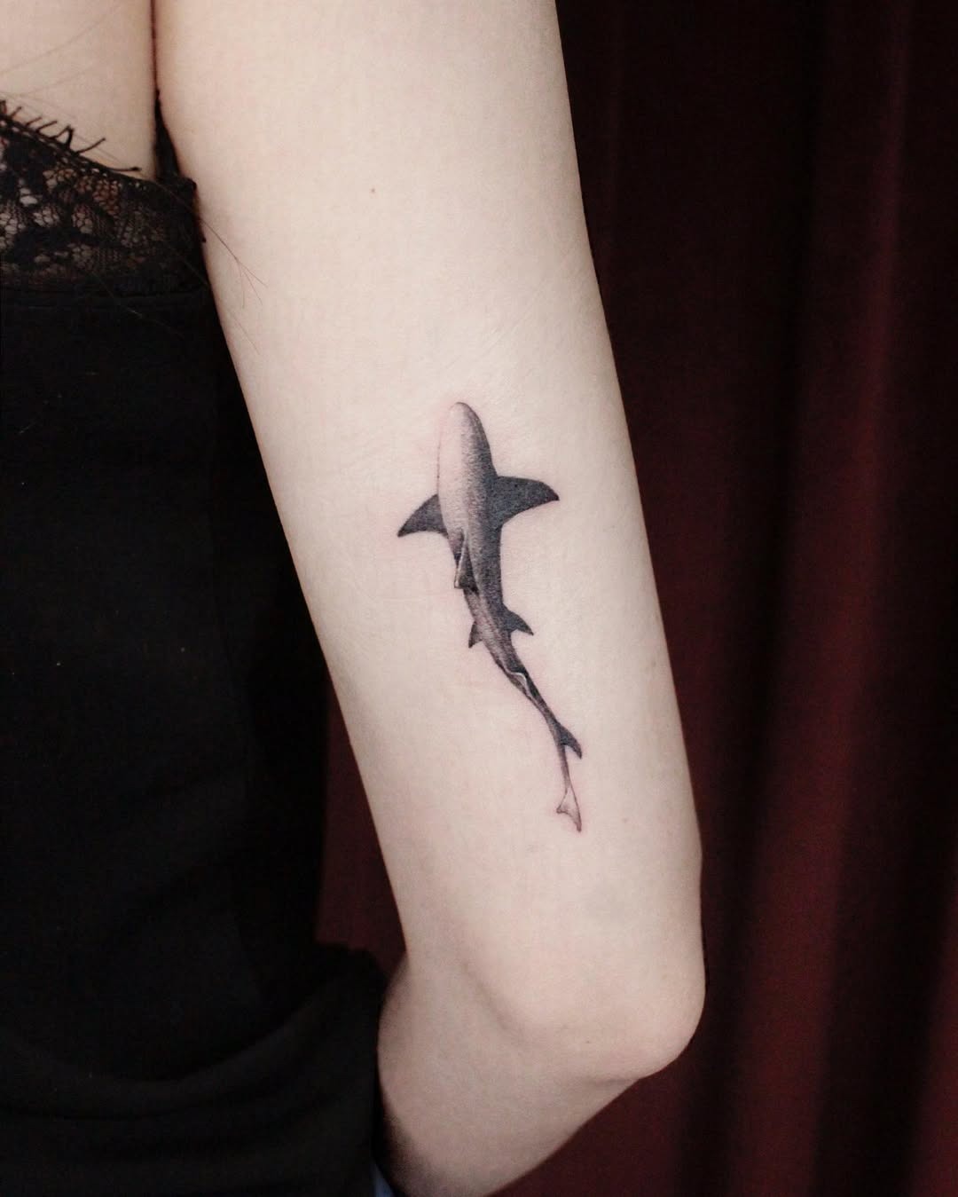 Sleek black ink shark tattoo on arm Tattoo Design