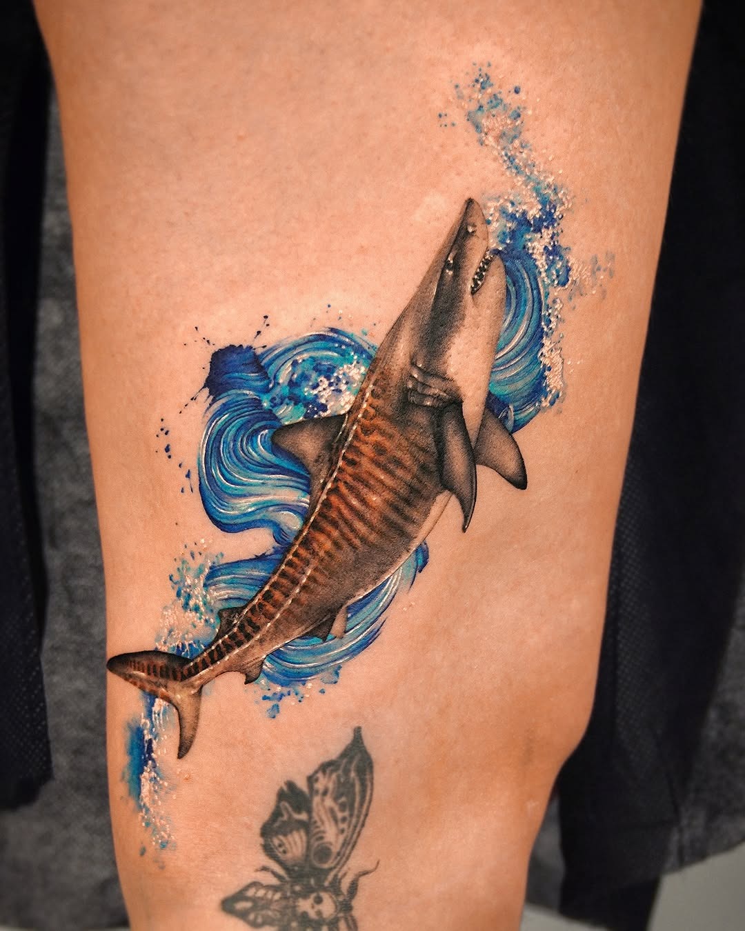 Stunning shark tattoo with dynamic water design Tattoo Design