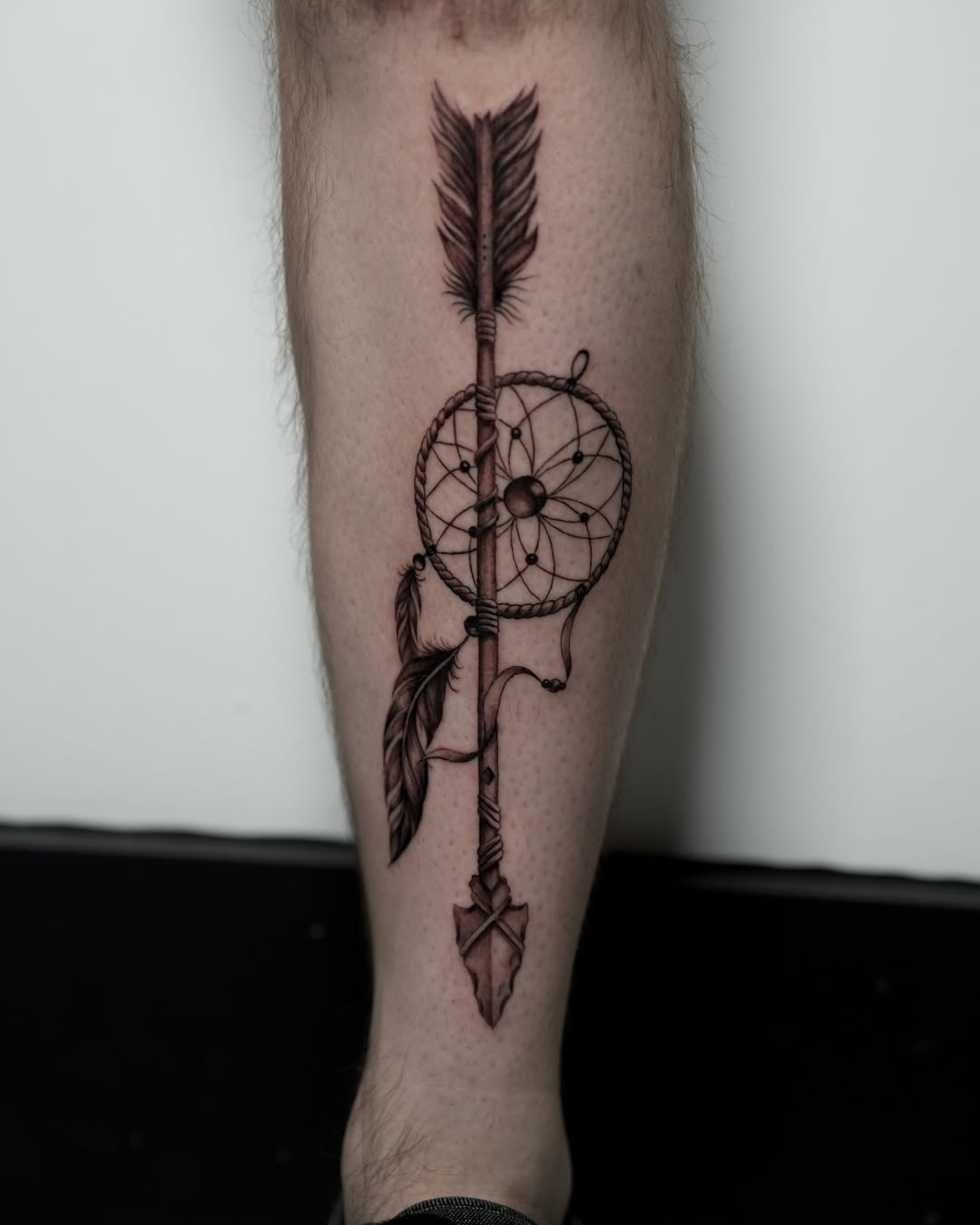 Dynamic dreamcatcher arrow tattoo for shin Tattoo Design