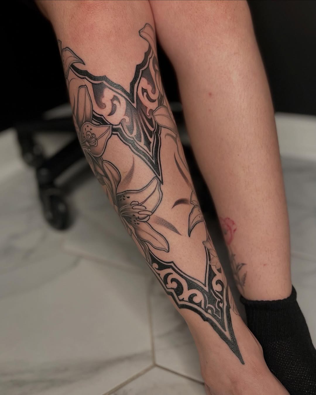 Elegant black and grey floral shin tattoo design Tattoo Design