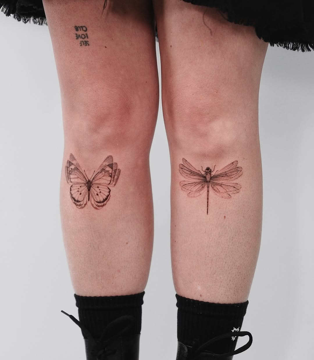 Elegant insect tattoos adorn this person’s shins Tattoo Design