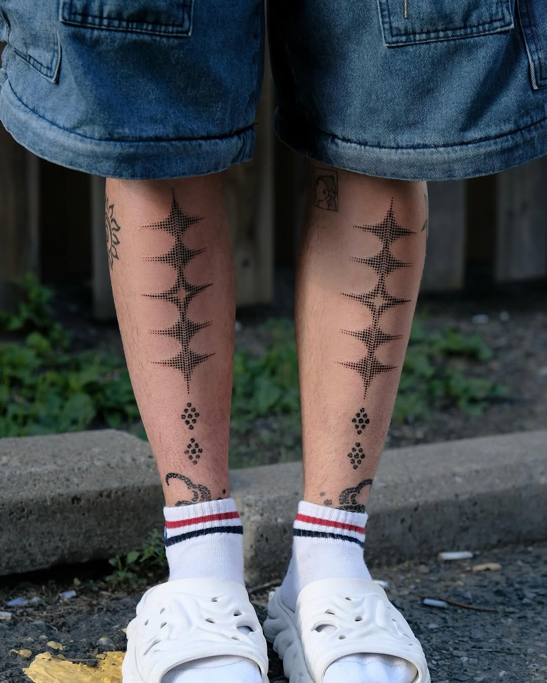 Intricate dotted patterns adorn the shins elegantly Tattoo Design