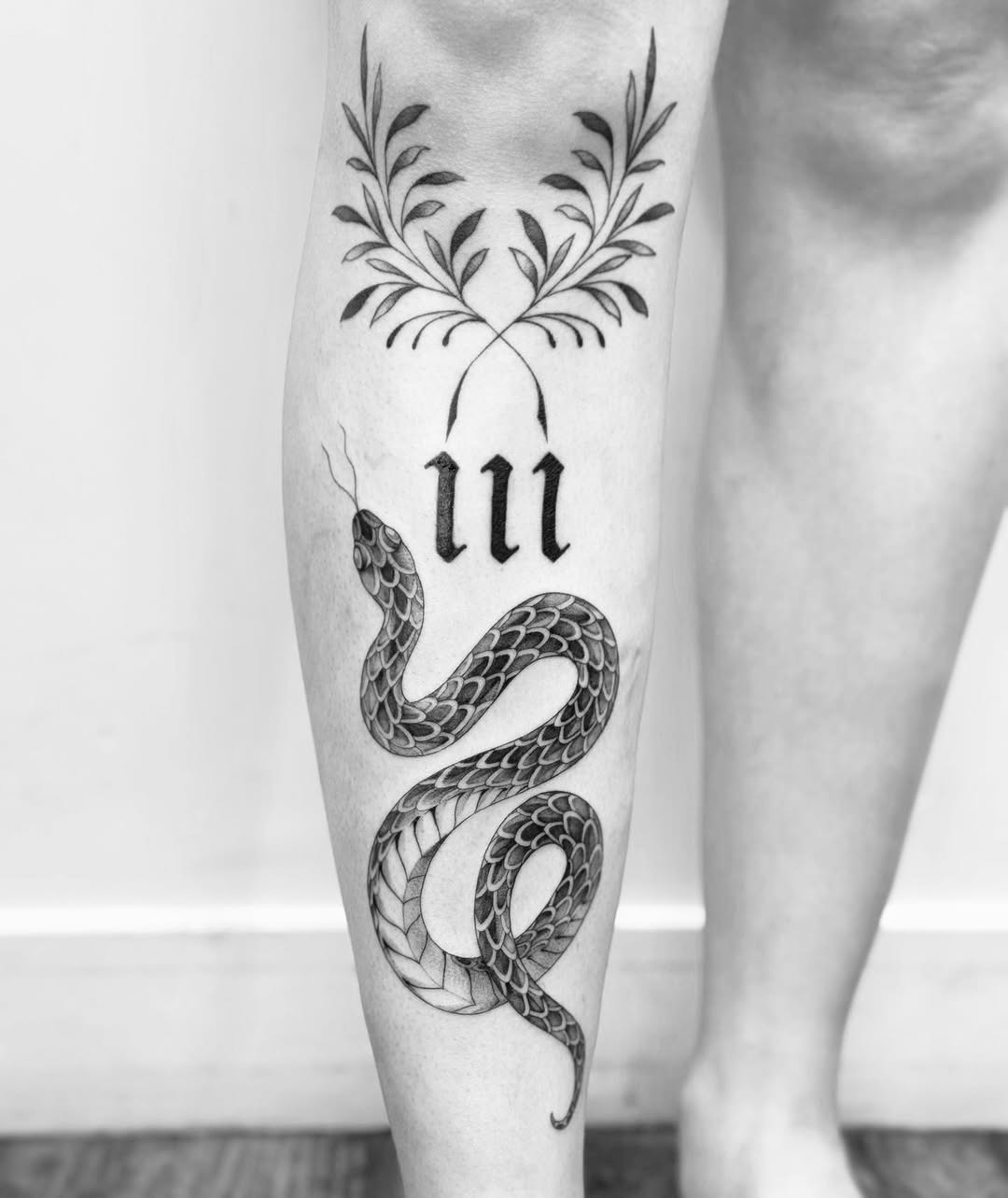 Intricate snake and floral shin tattoo design Tattoo Design