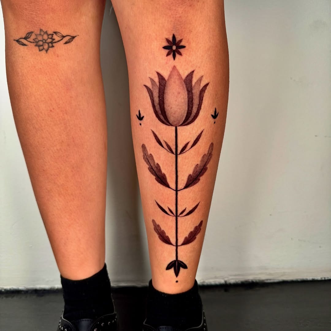 Stunning floral shin tattoo with bold lines Tattoo Design