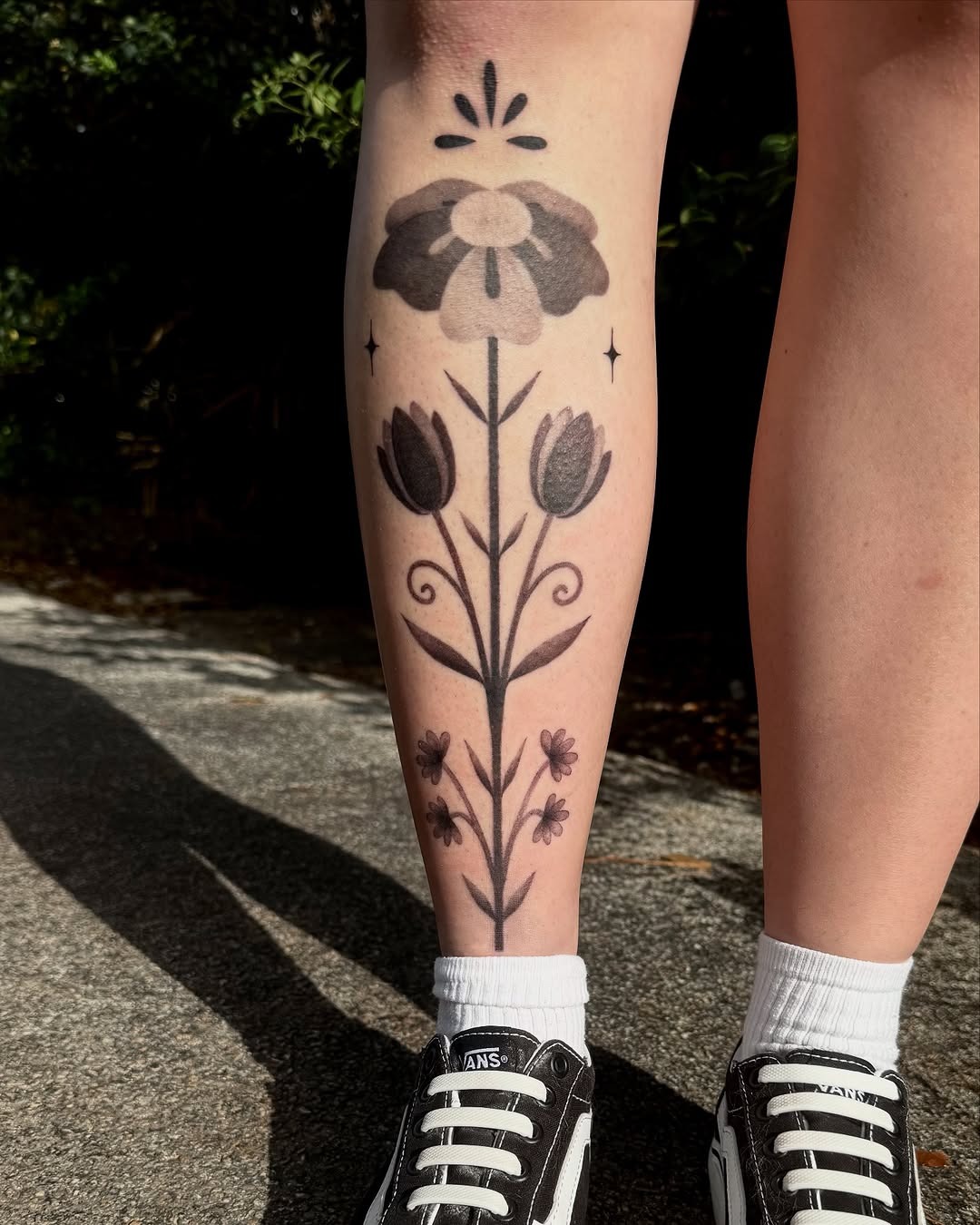 Stylish floral shin tattoo in black and grey Tattoo Design