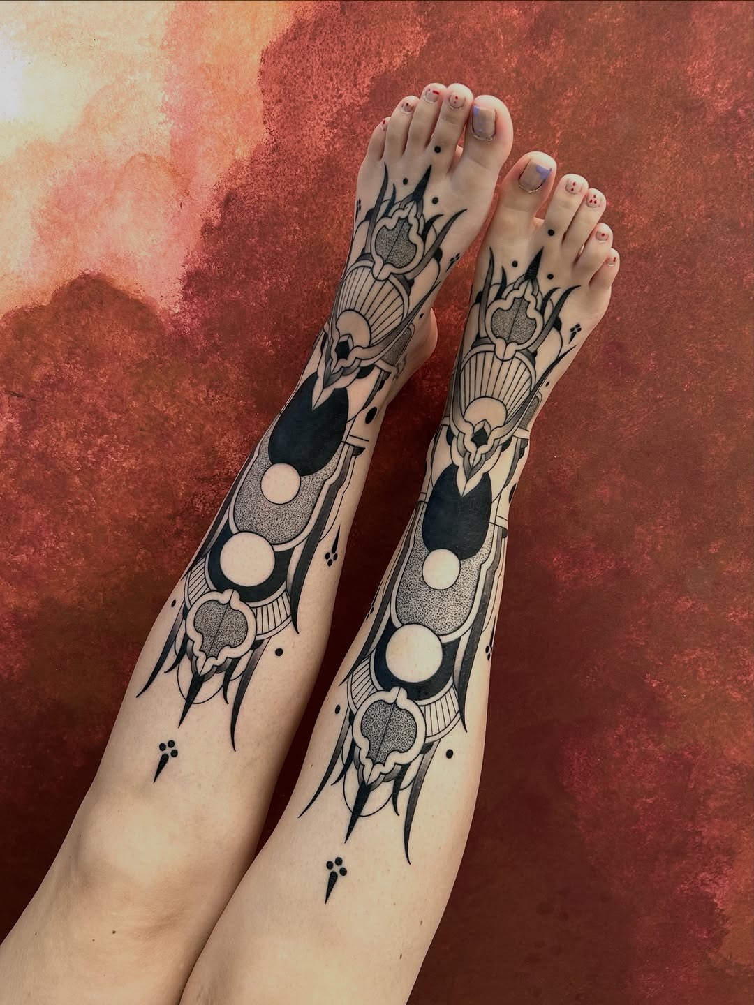 Unique blackwork designs grace the shins Tattoo Design