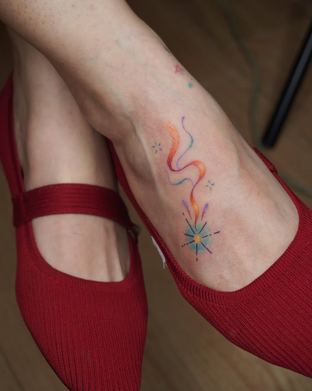 Colorful shooting star design on the ankle Tattoo Design