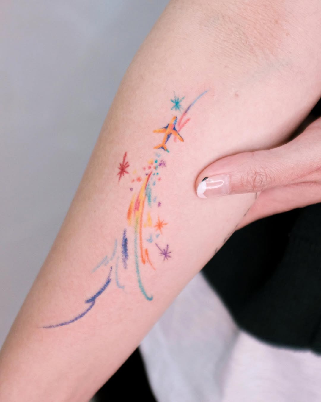 Colorful shooting star tattoo on the arm Tattoo Design