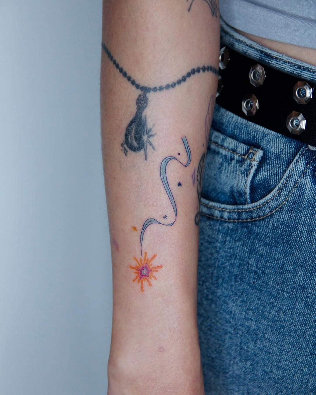 Colorful shooting star tattoo on the forearm Tattoo Design