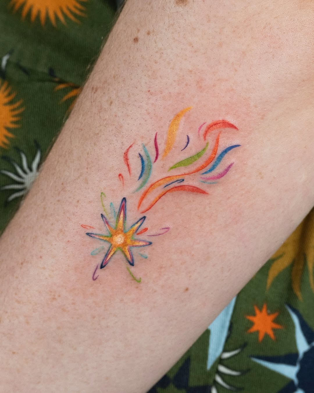 Vibrant shooting star tattoo with rainbow trails Tattoo Design