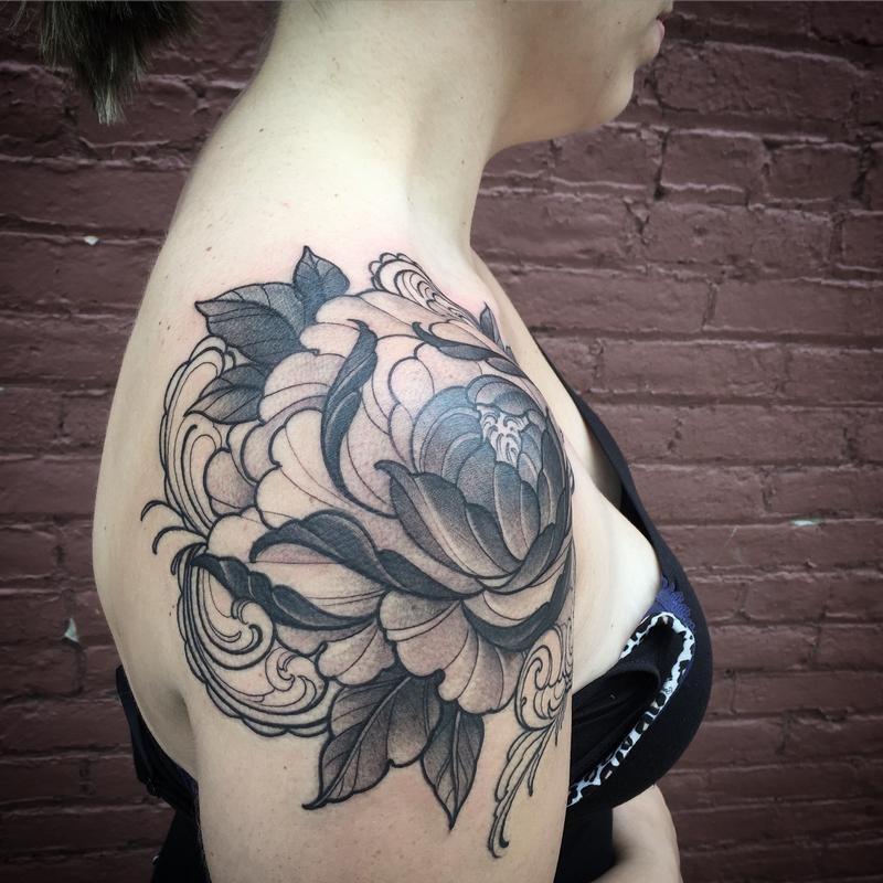 This design is a captivating example of a women flower shoulder cap tattoo.