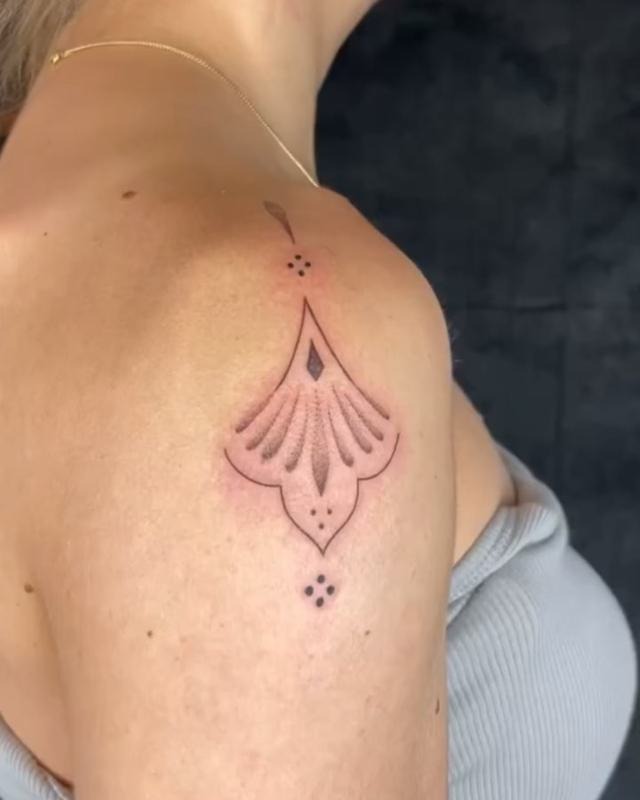 For those who appreciate a more minimalist approach, this small ornamental tattoo is a perfect choice.