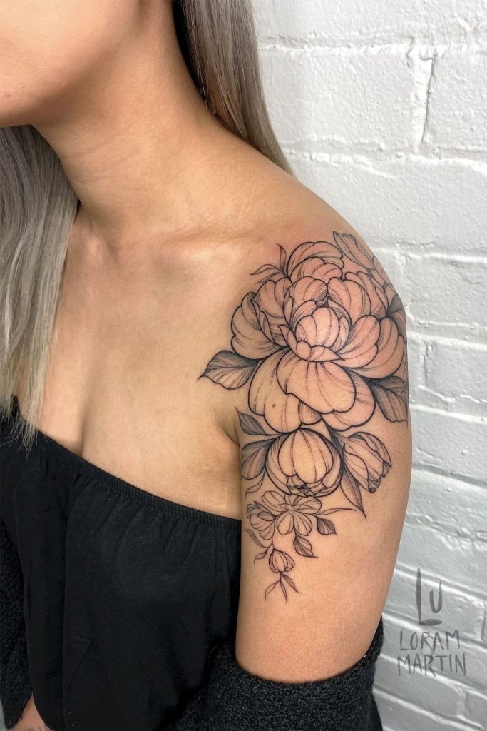 This women feminine shoulder tattoo is a more delicate and subtle take on floral tattoos.