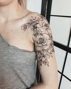 For those who prefer a monochromatic approach, this black and grey floral tattoo is a stunning choice.