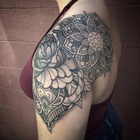 This shoulder cap tattoo blends mandala elements with floral artistry, creating a stunning women unique mandala design.