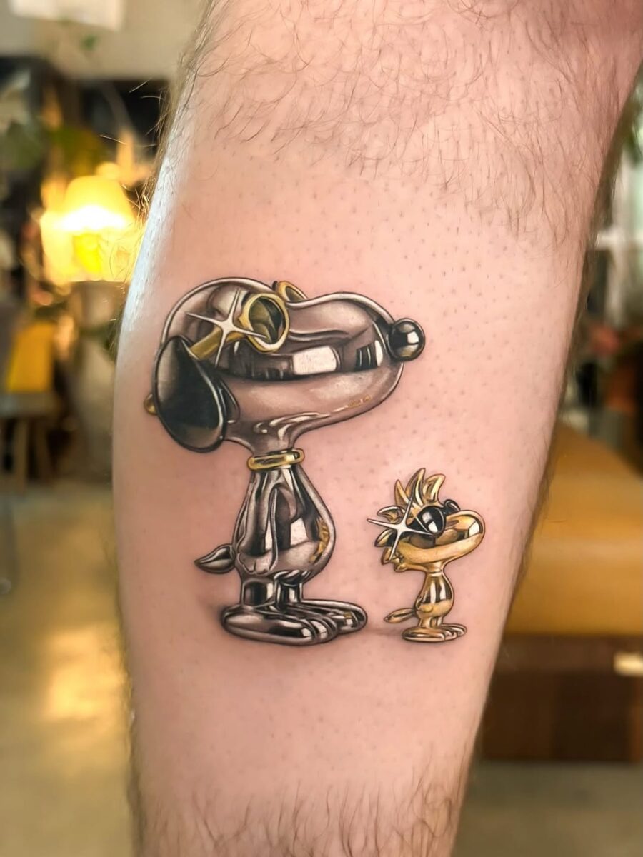 Charming silver ink tattoo of cartoon dog duo Tattoo Design
