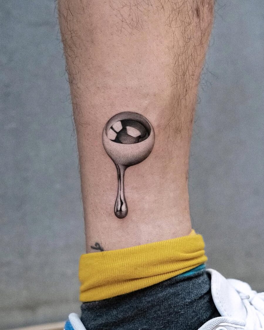 Elegant silver ink tattoo with a unique drip effect Tattoo Design