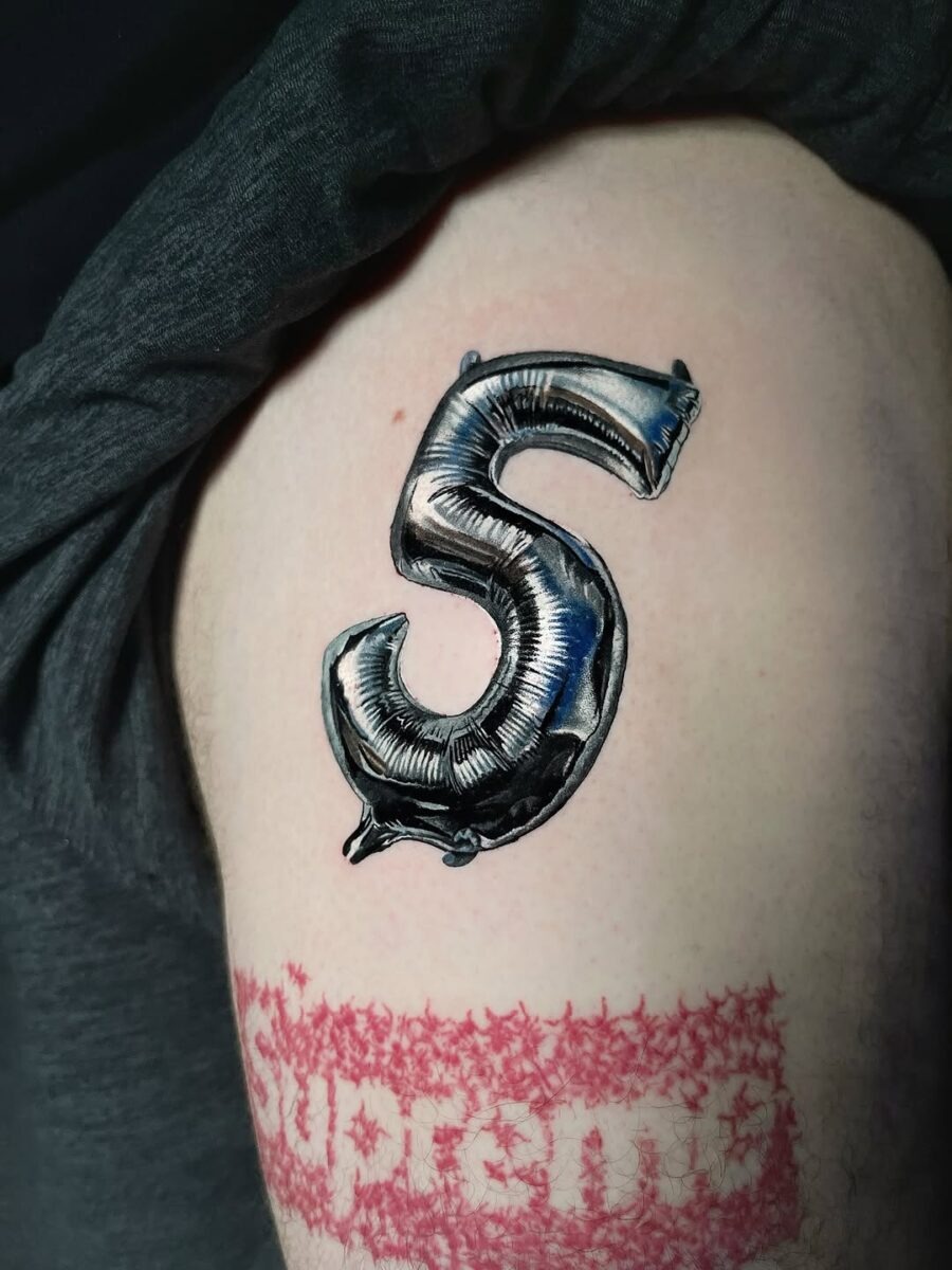 Shiny silver ink balloon number tattoo Tattoo Design