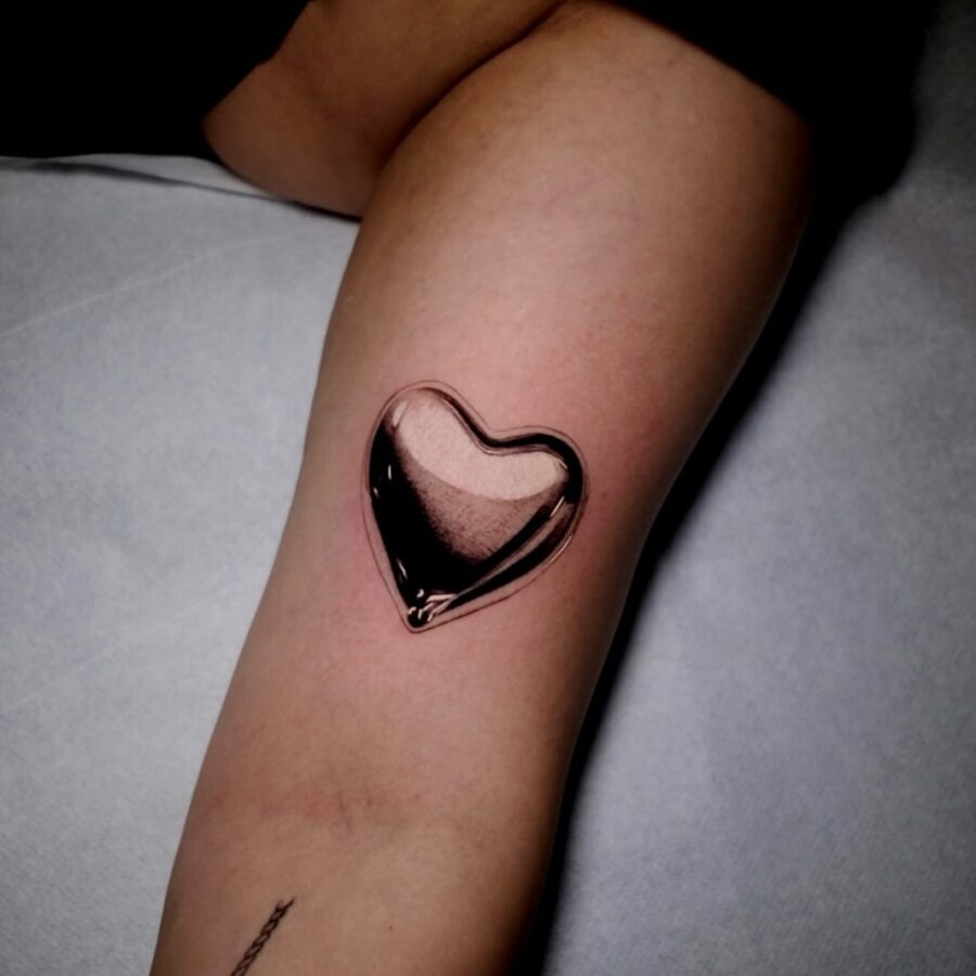 Stunning silver heart tattoo with a glossy finish Tattoo Design