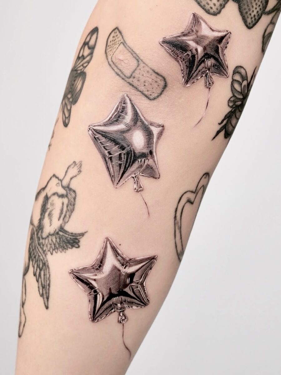 Stylish silver balloon tattoos on the arm Tattoo Design