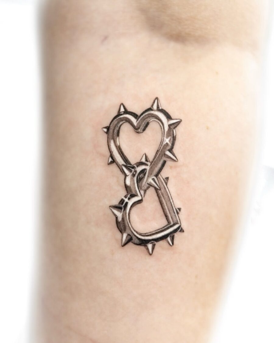 Stylish spiked heart tattoo in silver ink Tattoo Design