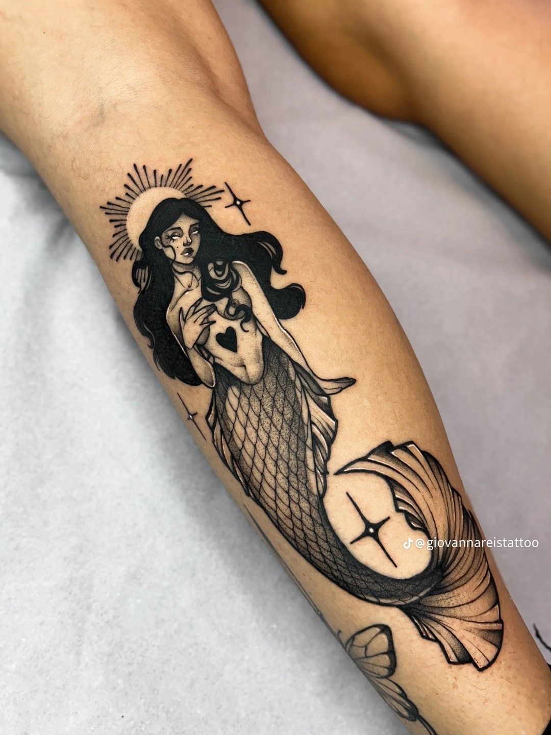 Dark Siren with Halo and Heart Symbol, a tattoo design rendered in bold.