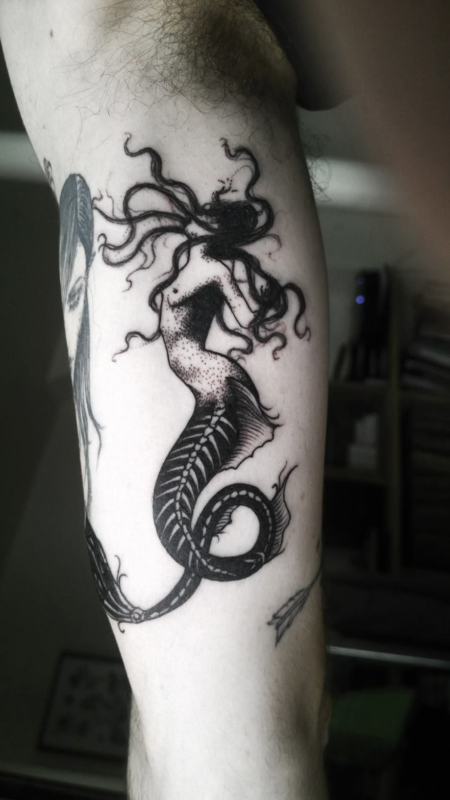 Shadowed Siren in Black Ink Motion, a tattoo design rendered in clean detailed linework.
