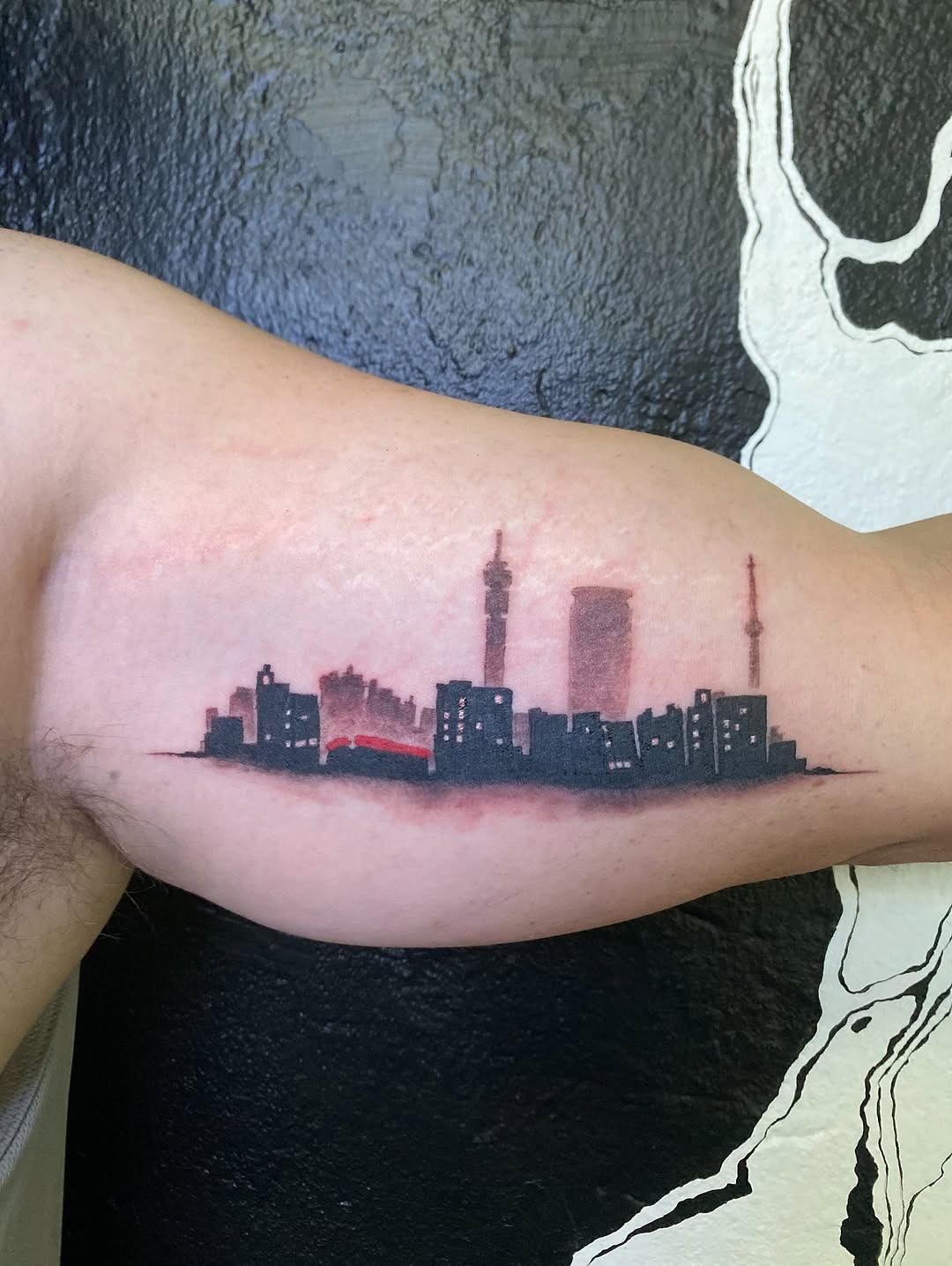 A striking skyline tattoo with vibrant hues Tattoo Design