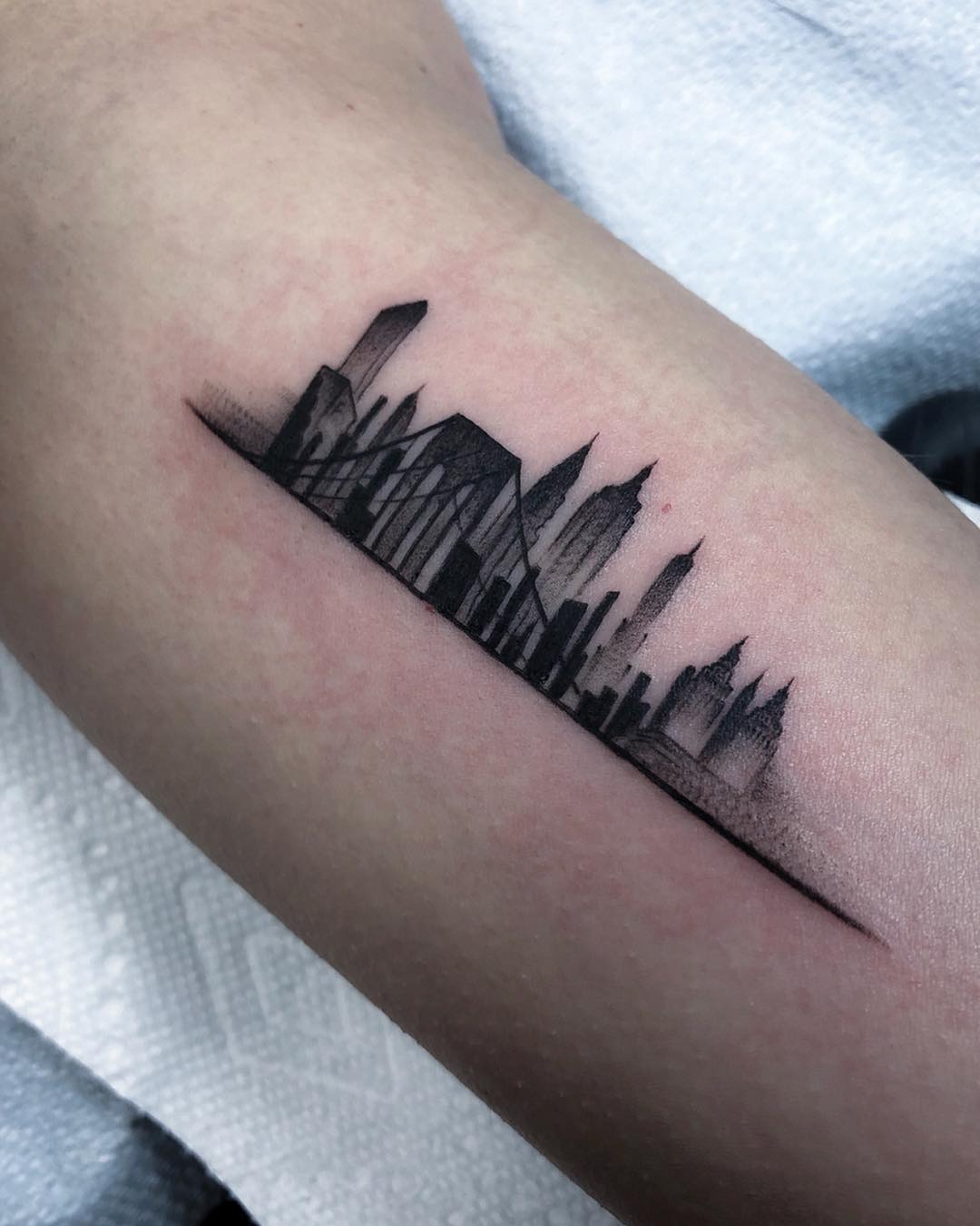 Elegant skyline tattoo with minimalist design Tattoo Design