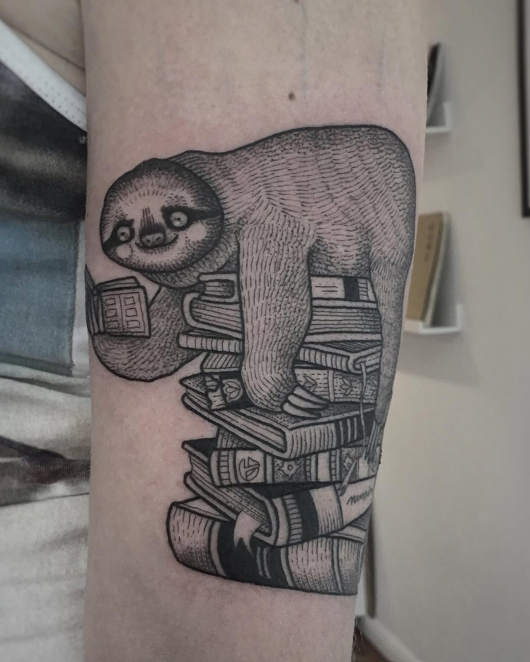 Charming sloth balancing on a book stack Tattoo Design