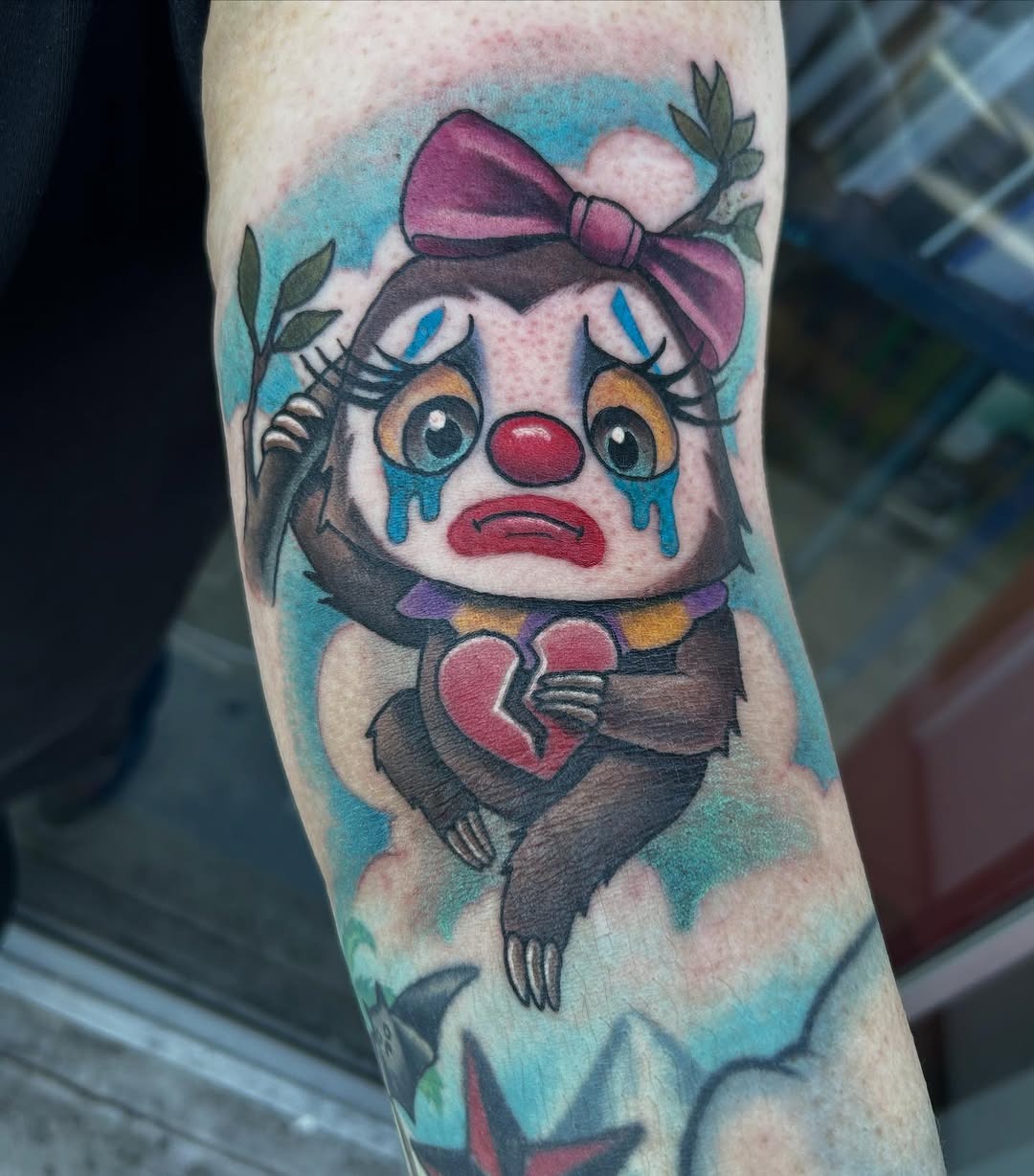 Whimsical sloth clown tattoo with emotional flair Tattoo Design