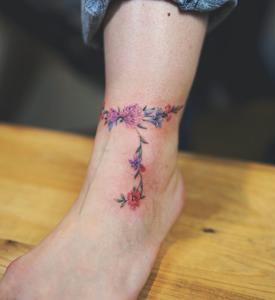 Colorful Floral Anklet Tattoo with Dangling Vine Tattoo Design