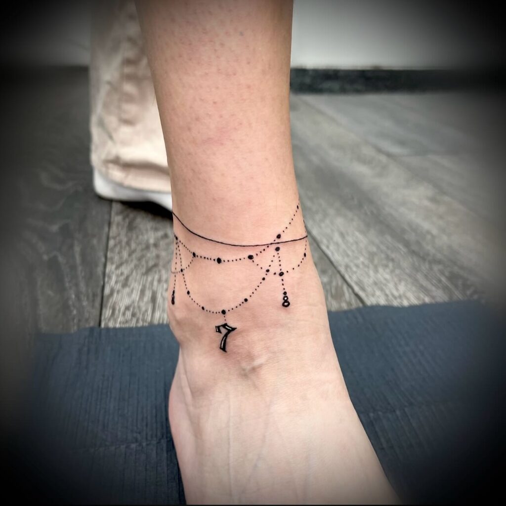 Elegant Anklet Tattoo with Hanging Number Charm Tattoo Design