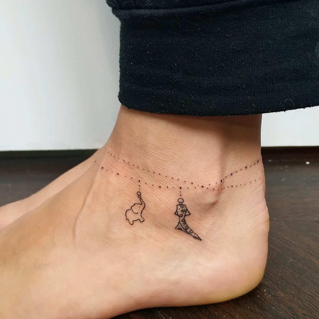 Minimalist Anklet Tattoo with Elephant and Clown Charms Tattoo Design