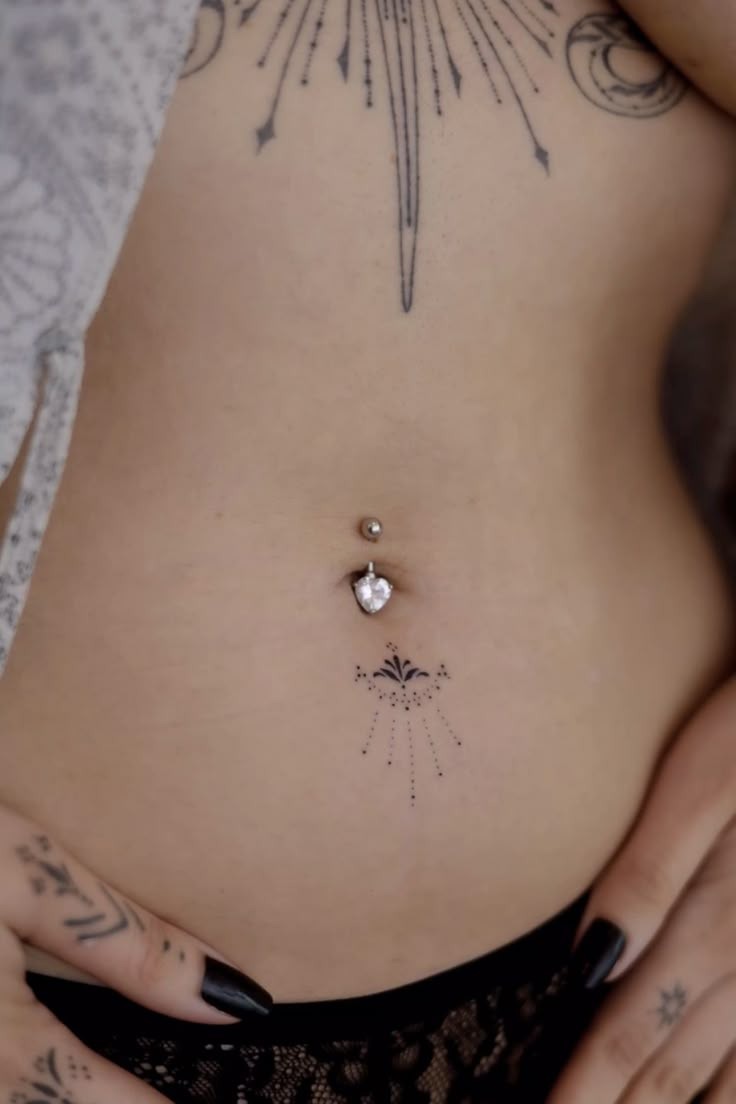 Delicate Starburst Below the Navel Tattoo Design