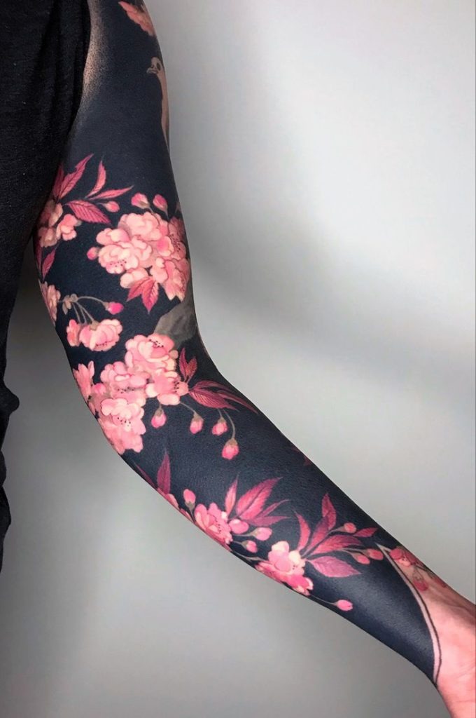 Elegant Dark Sleeve with Pink Blossoms Tattoo Design